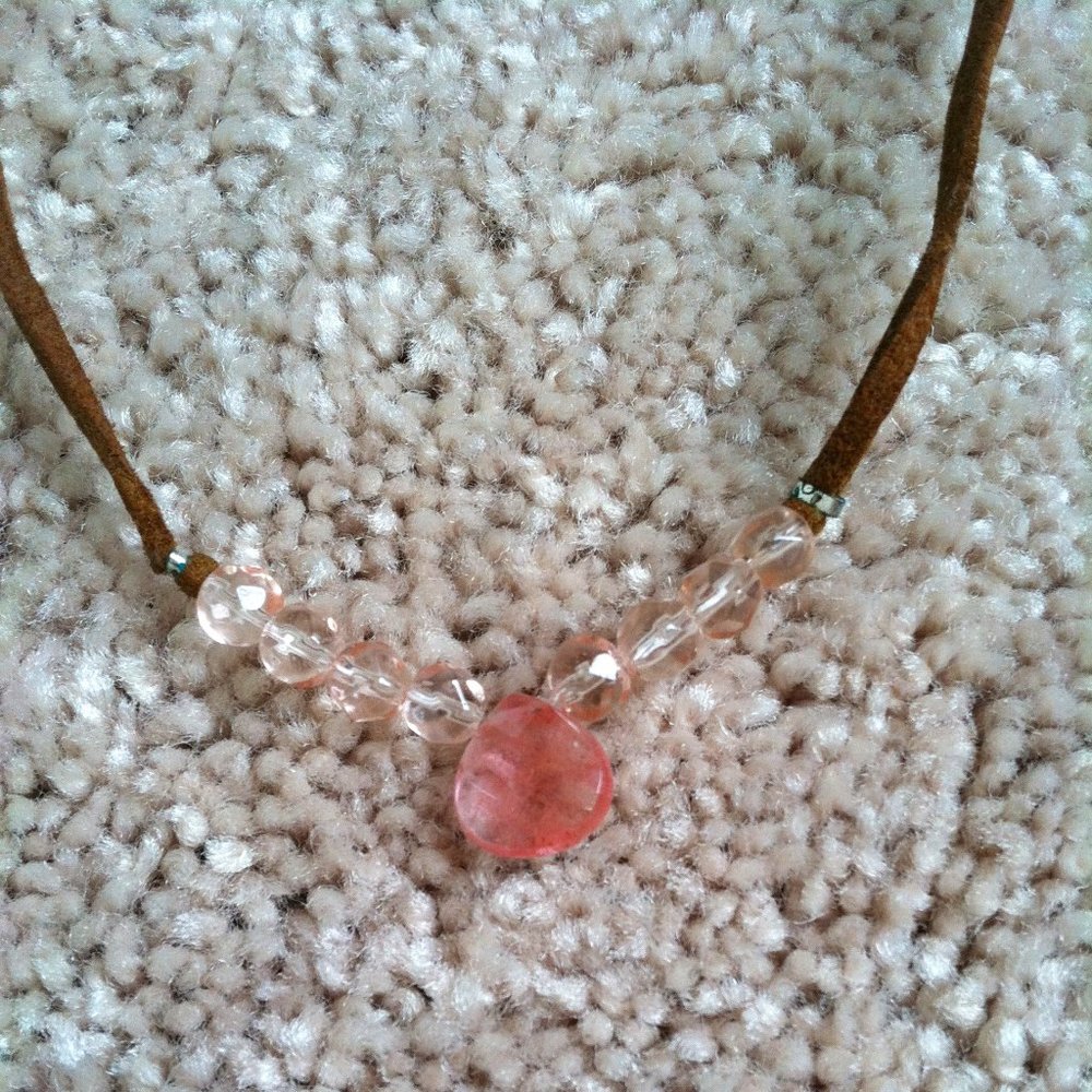 Necklace: leather thong with pink gem